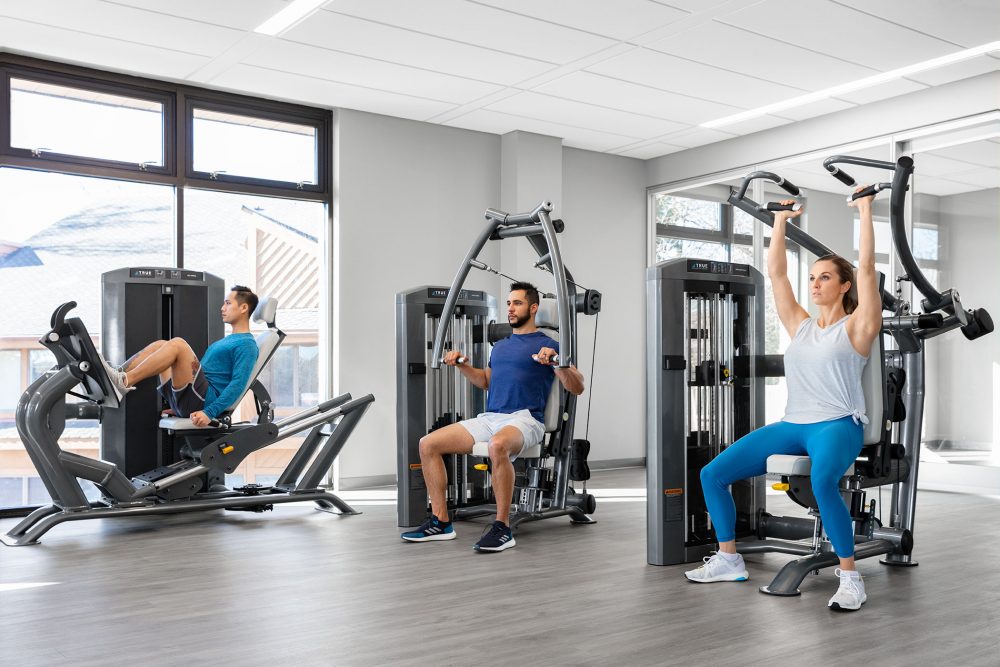 Commercial fitness products or strength machines being used at a commercial gym.