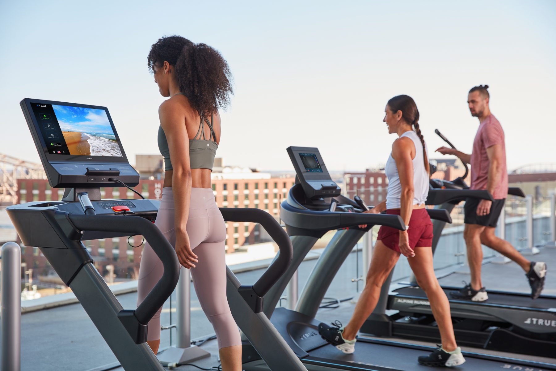 Commercial treadmills being used on a rooftop facility.