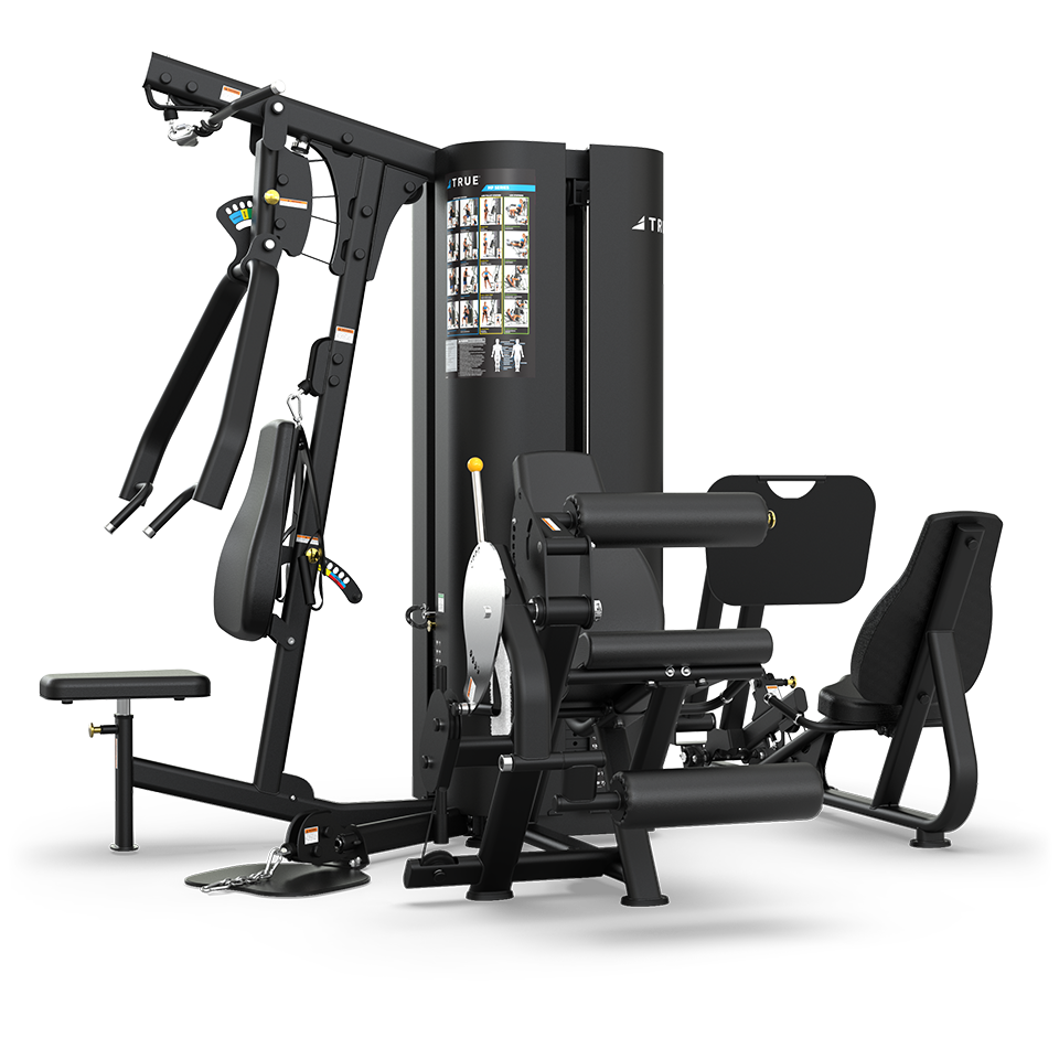A multi-station gym machine with various attachments for strength training, including a bench, leg extension, arm press, and illustrated instructions on the central column. The equipment is black with silver accents.