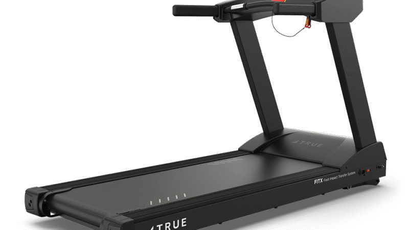 A modern black treadmill with a large screen display, wide running deck, and sturdy handrails, branded “TRUE,” against a plain white background.