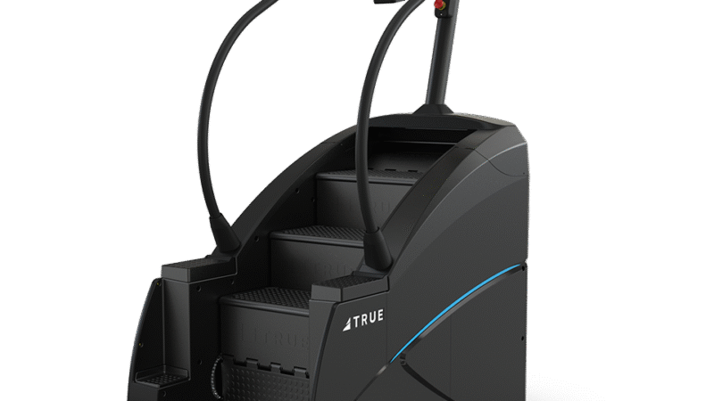 A black stair-climbing exercise machine with handrails, a built-in touchscreen display, and the brand name TRUE on the side, set against a plain white background.